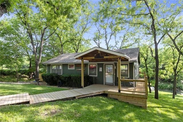 321 W Sugarlake Dr, Mound City, KS 66056 - bungalow-style house with a front yard, a shingled roof, and a wooden deck