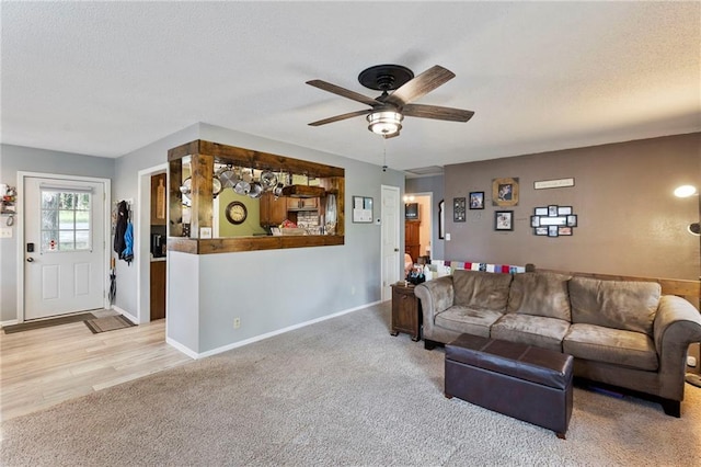 321 W Sugarlake Dr, Mound City, KS 66056 - living area featuring a ceiling fan, light colored carpet, and a textured ceiling
