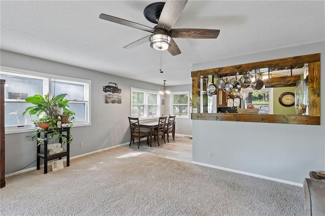 321 W Sugarlake Dr, Mound City, KS 66056 - carpeted dining space with a textured ceiling, ceiling fan, and a chandelier