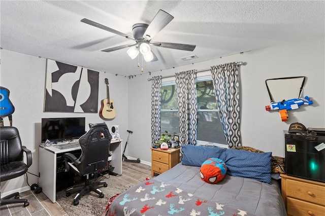 321 W Sugarlake Dr, Mound City, KS 66056 - bedroom featuring wood finish floors, a textured ceiling, ceiling fan, and a desk