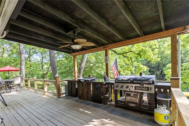 321 W Sugarlake Dr, Mound City, KS 66056 - wooden terrace featuring outdoor dining space, ceiling fan, a grill, and view of scattered trees