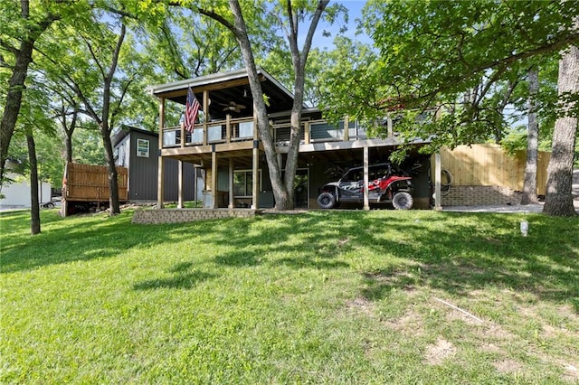 321 W Sugarlake Dr, Mound City, KS 66056 - rear view of house with a lawn and a wooden deck