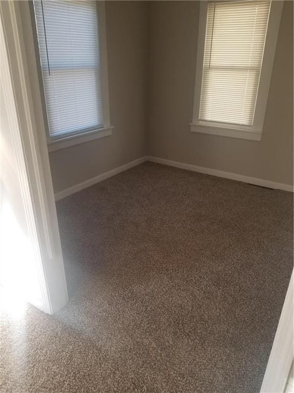 7403 Montgall Ave, Kansas City, MO 64132 - carpeted empty room with baseboards