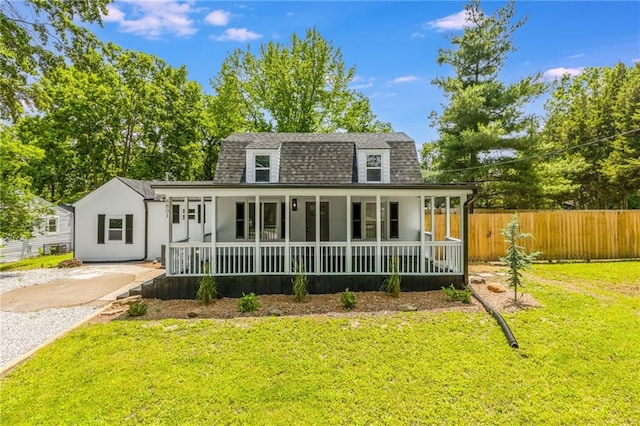 8801 E 49th St, Kansas City, MO 64129 - view of front facade featuring roof with shingles and covered porch