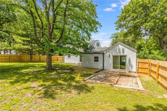8801 E 49th St, Kansas City, MO 64129 - fenced backyard with a patio
