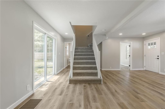 8801 E 49th St, Kansas City, MO 64129 - foyer featuring recessed lighting, stairs, and light wood-type flooring