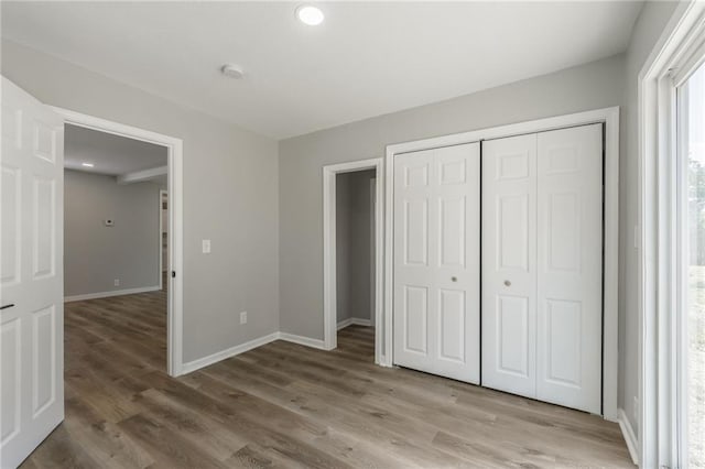8801 E 49th St, Kansas City, MO 64129 - unfurnished bedroom featuring light wood-style flooring and a closet