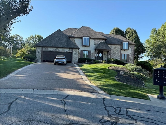 4328 W 110th St, Leawood, KS 66211 - french country style house featuring stone siding, driveway, a front yard, and an attached garage