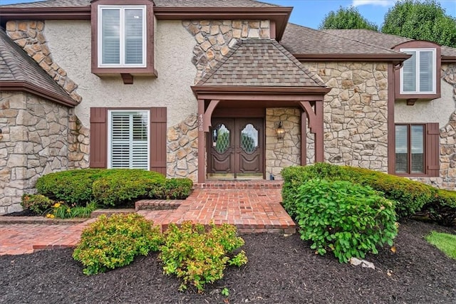 4328 W 110th St, Leawood, KS 66211 - property entrance with stone siding, roof with shingles, and stucco siding