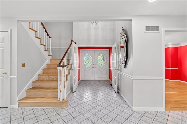 4328 W 110th St, Leawood, KS 66211 - foyer entrance with stairs, french doors, and tile patterned flooring
