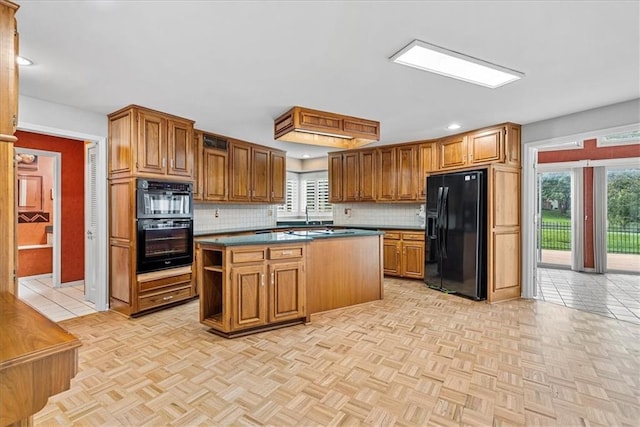 4328 W 110th St, Leawood, KS 66211 - kitchen featuring black appliances, dark countertops, tasteful backsplash, a kitchen island, and recessed lighting