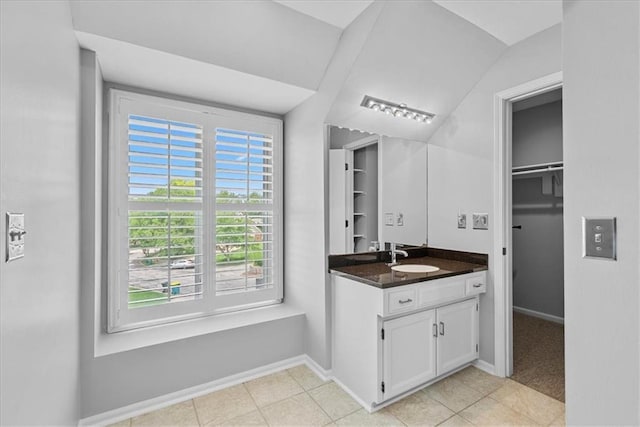 4328 W 110th St, Leawood, KS 66211 - bathroom featuring vanity, tile patterned flooring, and a walk in closet