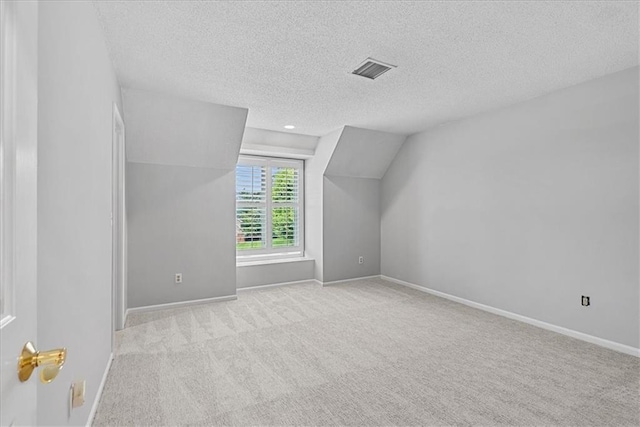 4328 W 110th St, Leawood, KS 66211 - bonus room featuring a textured ceiling, vaulted ceiling, and carpet flooring
