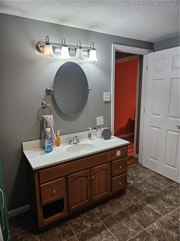 245 S 250th St, Pittsburg, KS 66762 - bathroom featuring vanity and a textured ceiling