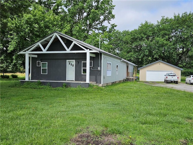 245 S 250th St, Pittsburg, KS 66762 - view of front of house featuring a garage, a front lawn, and an outbuilding