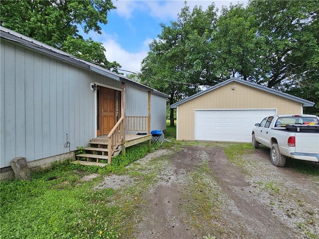 245 S 250th St, Pittsburg, KS 66762 - view of property exterior featuring a detached garage and an outbuilding