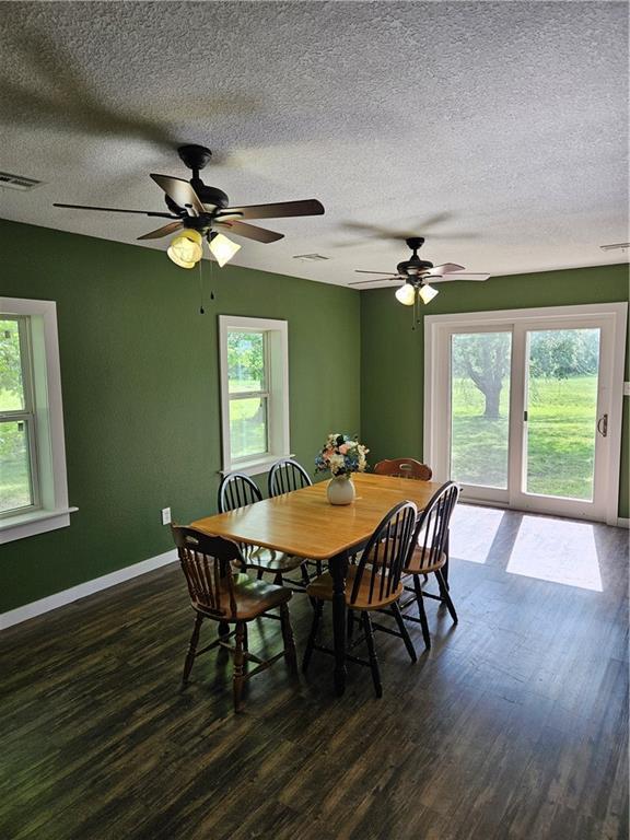 245 S 250th St, Pittsburg, KS 66762 - dining space featuring plenty of natural light, a textured ceiling, and dark wood-style flooring