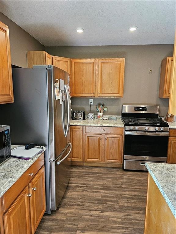245 S 250th St, Pittsburg, KS 66762 - kitchen with appliances with stainless steel finishes, dark wood-type flooring, a textured ceiling, and recessed lighting