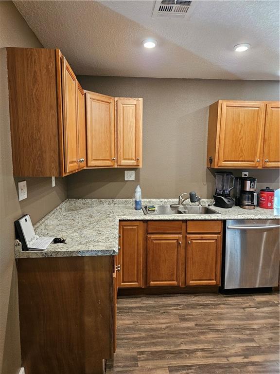 245 S 250th St, Pittsburg, KS 66762 - kitchen featuring stainless steel dishwasher, dark wood-type flooring, a textured ceiling, and recessed lighting