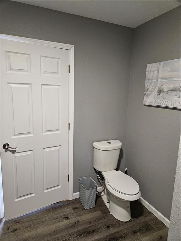 245 S 250th St, Pittsburg, KS 66762 - bathroom featuring wood finished floors and toilet