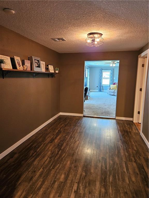 245 S 250th St, Pittsburg, KS 66762 - empty room featuring wood finished floors and a textured ceiling