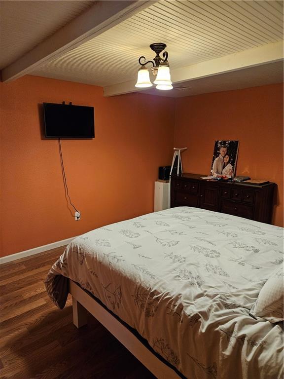 245 S 250th St, Pittsburg, KS 66762 - bedroom with dark wood-style floors and beamed ceiling