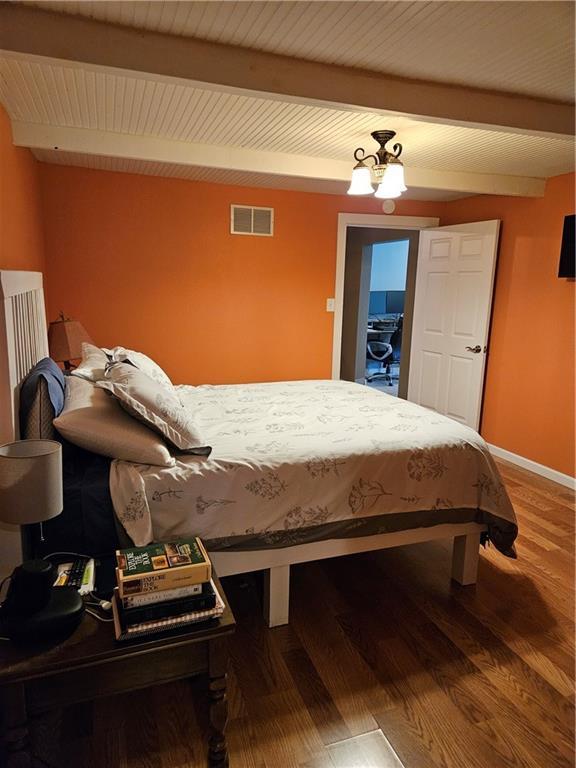 245 S 250th St, Pittsburg, KS 66762 - bedroom featuring beamed ceiling and wood finished floors