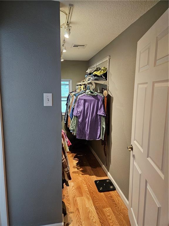 245 S 250th St, Pittsburg, KS 66762 - walk in closet featuring wood finished floors