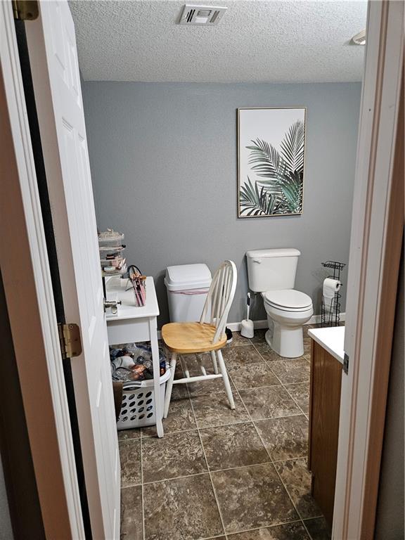 245 S 250th St, Pittsburg, KS 66762 - bathroom with a textured ceiling and vanity