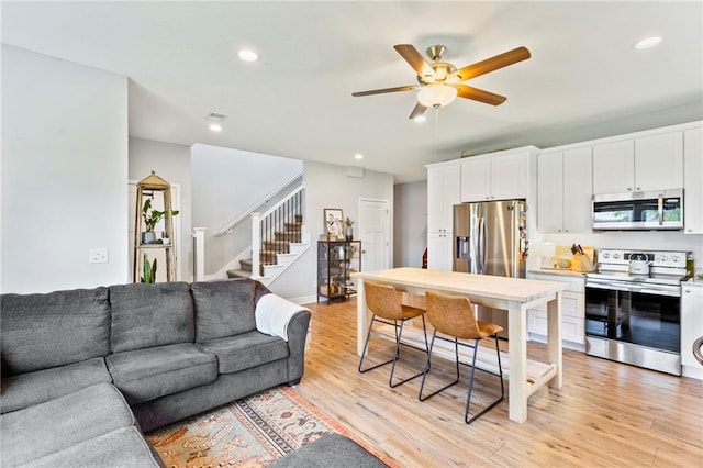 201 SW 12th St, Oak Grove, MO 64075 - living room featuring stairs, a ceiling fan, recessed lighting, and light wood finished floors