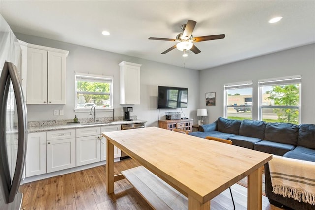 201 SW 12th St, Oak Grove, MO 64075 - kitchen with open floor plan, white cabinets, recessed lighting, stainless steel appliances, and ceiling fan