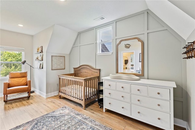 201 SW 12th St, Oak Grove, MO 64075 - bedroom with a nursery area, lofted ceiling, light wood-style flooring, and recessed lighting