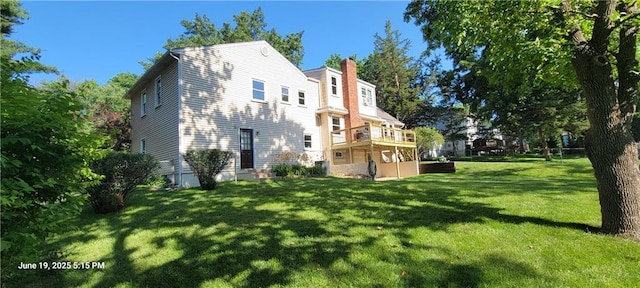 8738 Horton St, Overland Park, KS 66207 - back of property with a yard, a chimney, and a deck