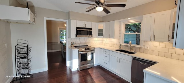 8738 Horton St, Overland Park, KS 66207 - kitchen with stainless steel appliances, dark wood-type flooring, ceiling fan, light countertops, and white cabinetry
