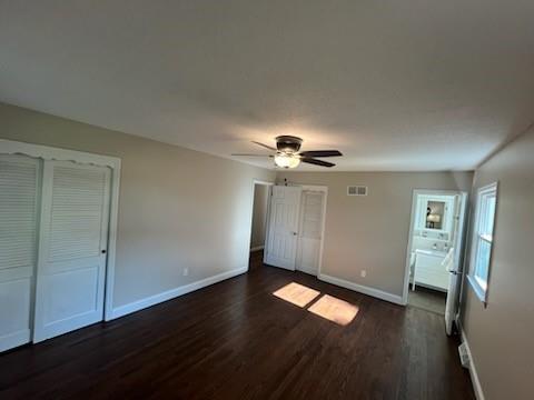 8738 Horton St, Overland Park, KS 66207 - unfurnished bedroom with dark wood-type flooring and ceiling fan