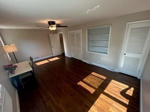 8738 Horton St, Overland Park, KS 66207 - unfurnished bedroom featuring wood finished floors, two closets, and a ceiling fan
