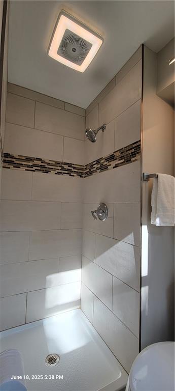 8738 Horton St, Overland Park, KS 66207 - bathroom with a tile shower and toilet