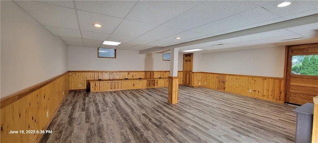8738 Horton St, Overland Park, KS 66207 - below grade area with wainscoting, wooden walls, a drop ceiling, wood finished floors, and recessed lighting