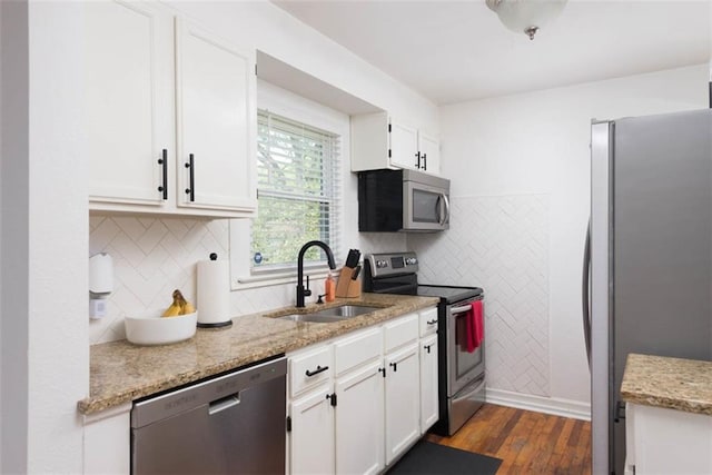 5915 Fontana St, Fairway, KS 66205 - kitchen featuring appliances with stainless steel finishes, dark wood-type flooring, white cabinets, light stone countertops, and tasteful backsplash