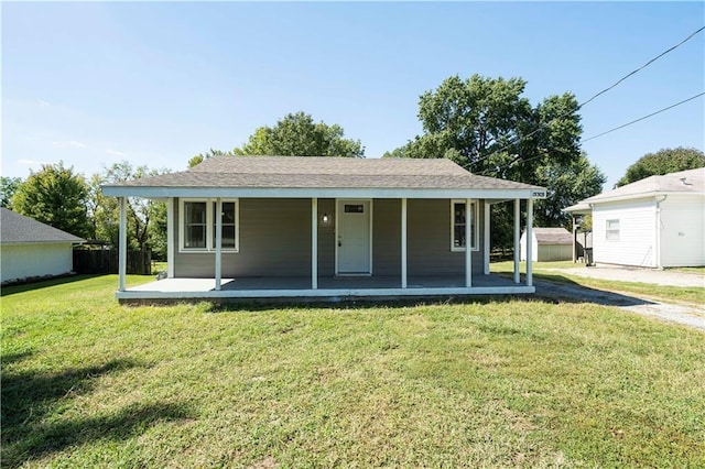 15309 E Mayes Rd, Independence, MO 64050 - view of front of house featuring covered porch, a front lawn, and a storage shed
