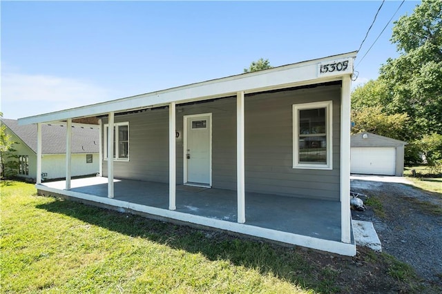 15309 E Mayes Rd, Independence, MO 64050 - back of house with a lawn, an outdoor structure, and a detached garage