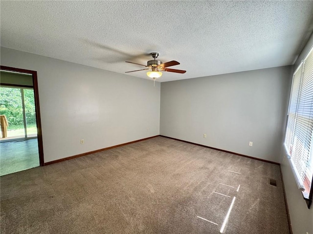 177 SE 411th Rd, Warrensburg, MO 64093 - carpeted empty room featuring healthy amount of natural light, a ceiling fan, and a textured ceiling