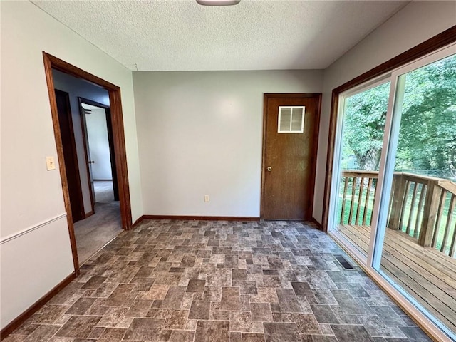 177 SE 411th Rd, Warrensburg, MO 64093 - empty room featuring stone finish flooring and a textured ceiling