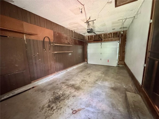 177 SE 411th Rd, Warrensburg, MO 64093 - garage featuring a garage door opener and wooden walls