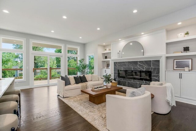 2201 W 74th St, Prairie Village, KS 66208 - living area featuring dark wood-style floors, recessed lighting, built in features, and a premium fireplace