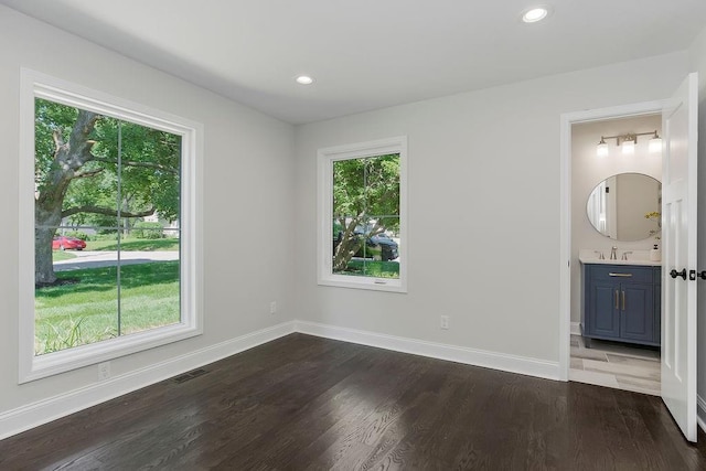 2201 W 74th St, Prairie Village, KS 66208 - unfurnished bedroom with dark wood finished floors, recessed lighting, and connected bathroom