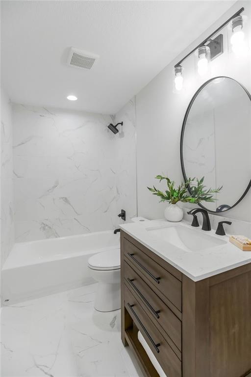 2201 W 74th St, Prairie Village, KS 66208 - full bath with vanity, shower / washtub combination, and marble finish flooring