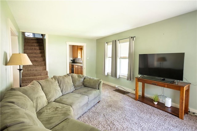 1619 W College St, Independence, MO 64050 - carpeted living room featuring stairs and baseboards