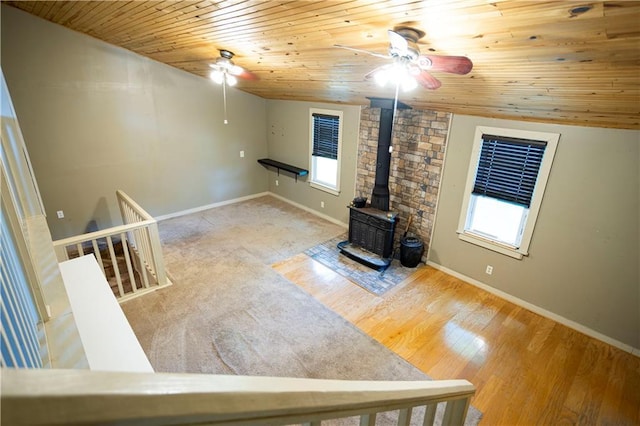 1619 W College St, Independence, MO 64050 - unfurnished living room with a ceiling fan, a wood stove, healthy amount of natural light, wood ceiling, and lofted ceiling