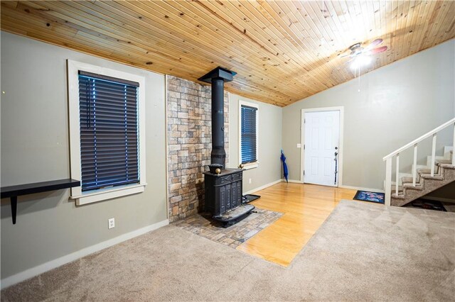 1619 W College St, Independence, MO 64050 - unfurnished living room featuring a wood stove, carpet, lofted ceiling, wood ceiling, and stairs